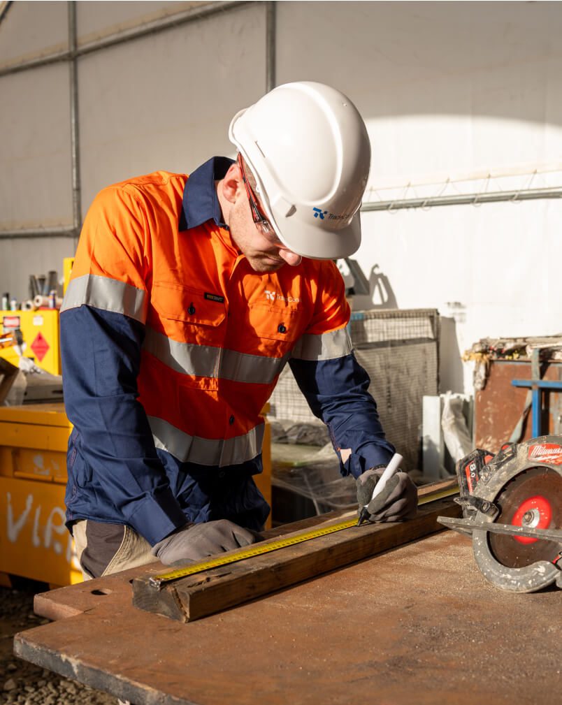 Carpenter on hire from TradeConnex Labour Hire measuring wood for cutting